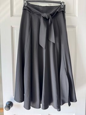 Belle Poque high-waisted A-line skirt with a flared hem, decorative waist tie.